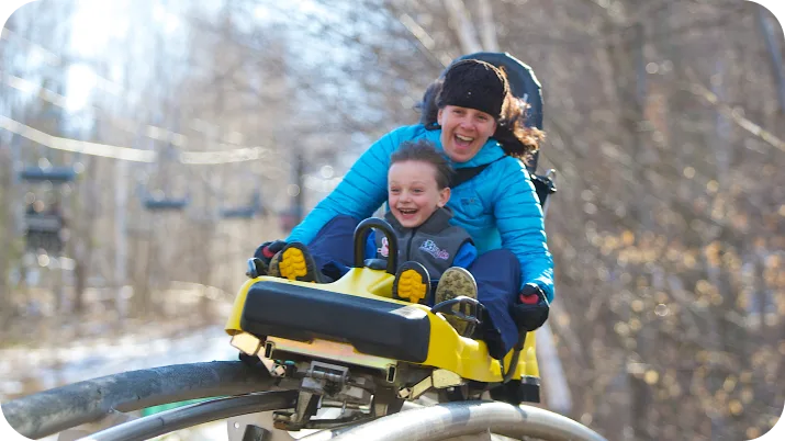Mother and son on mountain coaster